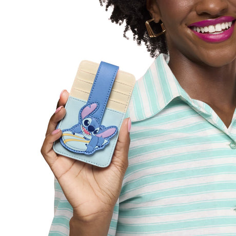 Officially licensed Disney Lilo & Stitch surfing faux leather card case featuring a light blue and cream color block design with a secure snap strap