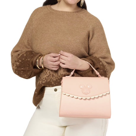 Officially licensed Disney Mickey Mouse & Friends light pink-colored tote crossbody bag featuring a 3D character emblem, scalloped trim, and embossed character patterns