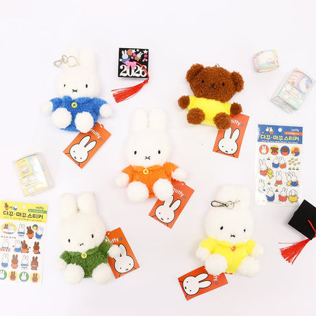 An officially licensed Class of 2026 Miffy graduation gift set featuring yellow, orange, green, and blue color Miffy plush and Boris plush wearing black graduation caps. The characters are arranged like a bouquet with silver star balloons and "Congrats Grad" decorations.
