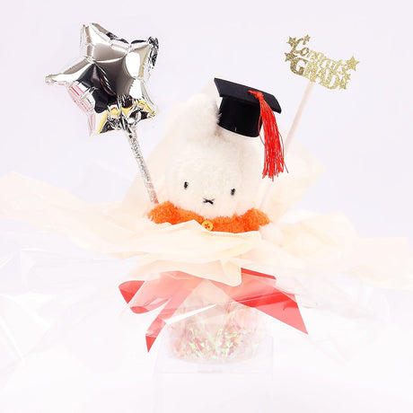 An officially licensed Class of 2026 Miffy graduation gift set featuring yellow, orange, green, and blue color Miffy plush and Boris plush wearing black graduation caps. The characters are arranged like a bouquet with silver star balloons and "Congrats Grad" decorations.