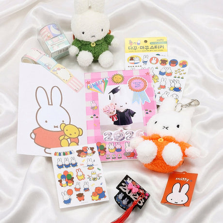 An officially licensed Class of 2026 Miffy graduation gift set featuring yellow, orange, green, and blue color Miffy plush and Boris plush wearing black graduation caps. The characters are arranged like a bouquet with silver star balloons and "Congrats Grad" decorations.