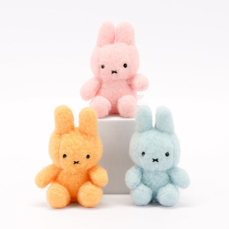 An officially licensed Class of 2026 Miffy graduation gift set featuring soft pink, orange, and blue color Miffy plush wearing black graduation caps. The characters are arranged like a bouquet with silver star balloons and "Congrats Grad" decorations.