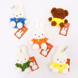 An officially licensed Class of 2026 Miffy graduation gift set featuring yellow, orange, green, and blue color Miffy plush and Boris plush wearing black graduation caps. The characters are arranged like a bouquet with silver star balloons and "Congrats Grad" decorations.