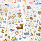 Four different officially licensed Miffy Epoxy Daily Sticker sheets, each featuring various colorful illustrations of the white bunny character and her animal friends. The stickers have a smooth, raised epoxy texture and depict playful scenes like Miffy riding a bicycle, sitting with a giraffe, and boating with a bear.
