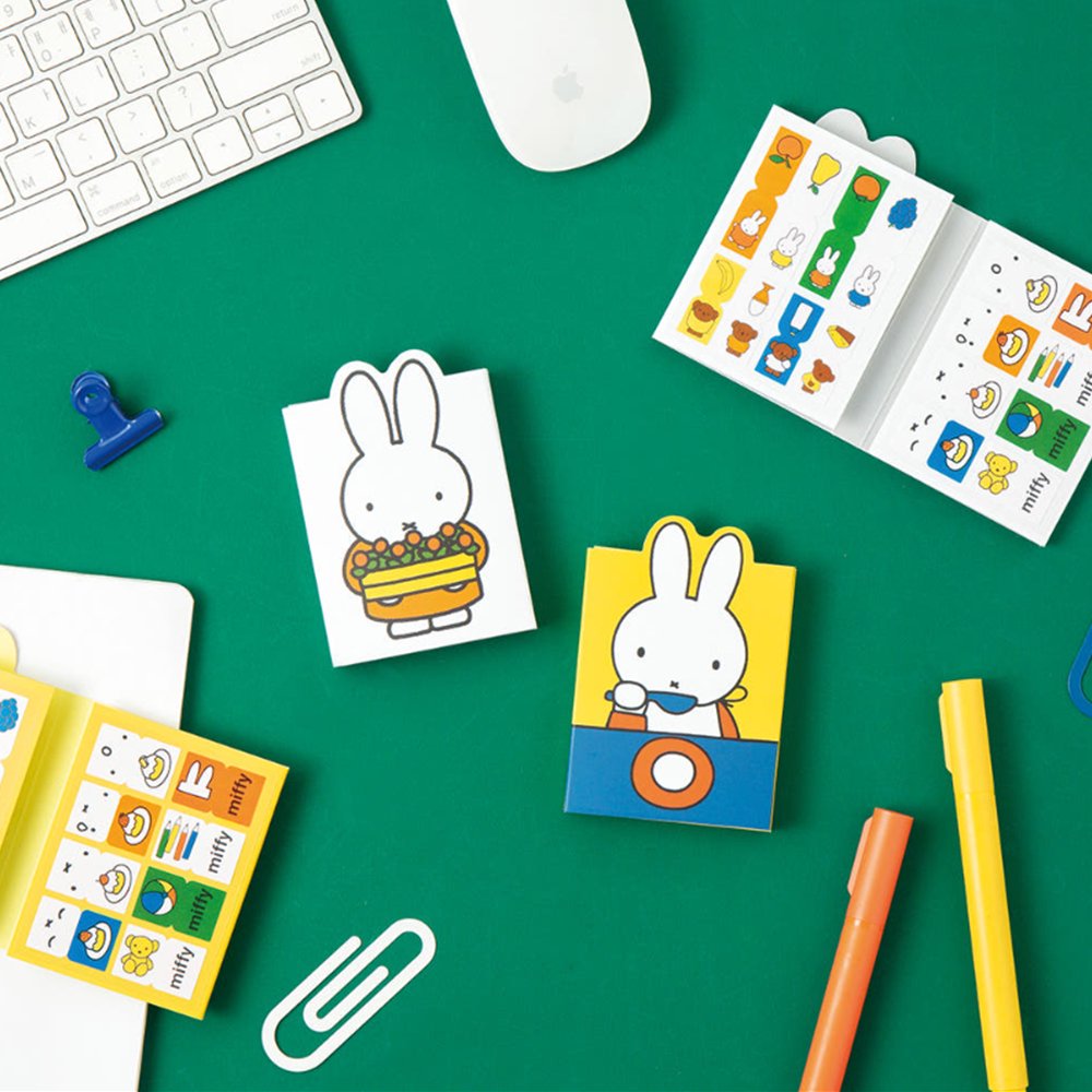 Officially licensed Miffy sticky note booklets featuring different covers—one showing Miffy holding a tray of orange flowers on a white background, and the other showing Miffy eating with a blue spoon on a yellow background