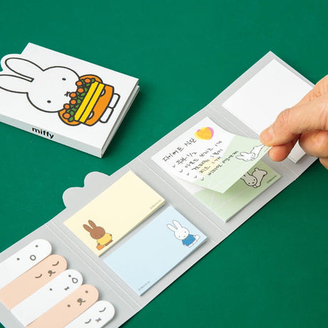 Officially licensed Miffy sticky note booklets featuring different covers—one showing Miffy holding a tray of orange flowers on a white background, and the other showing Miffy eating with a blue spoon on a yellow background