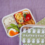 An officially licensed Miffy bento lunch box including a divider with a cream-colored base and dusty rose locking clips