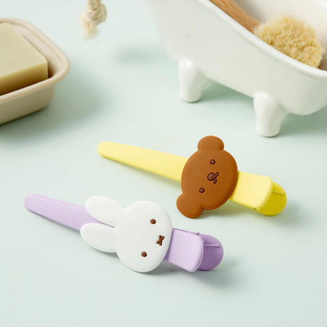 Officially licensed Miffy salon-style big hair clips, featuring one in pastel purple with a white Miffy bunny charm, and the other one in pastel yellow with a brown Boris Bear charm.