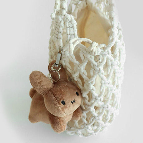 Warm Brown Miffy bunny  plush keychain with a minimalist X-shaped mouth. This classic cream-white collector's item offers visual rest and childhood nostalgia for millennials decorating bag or your minimalist workspaces.