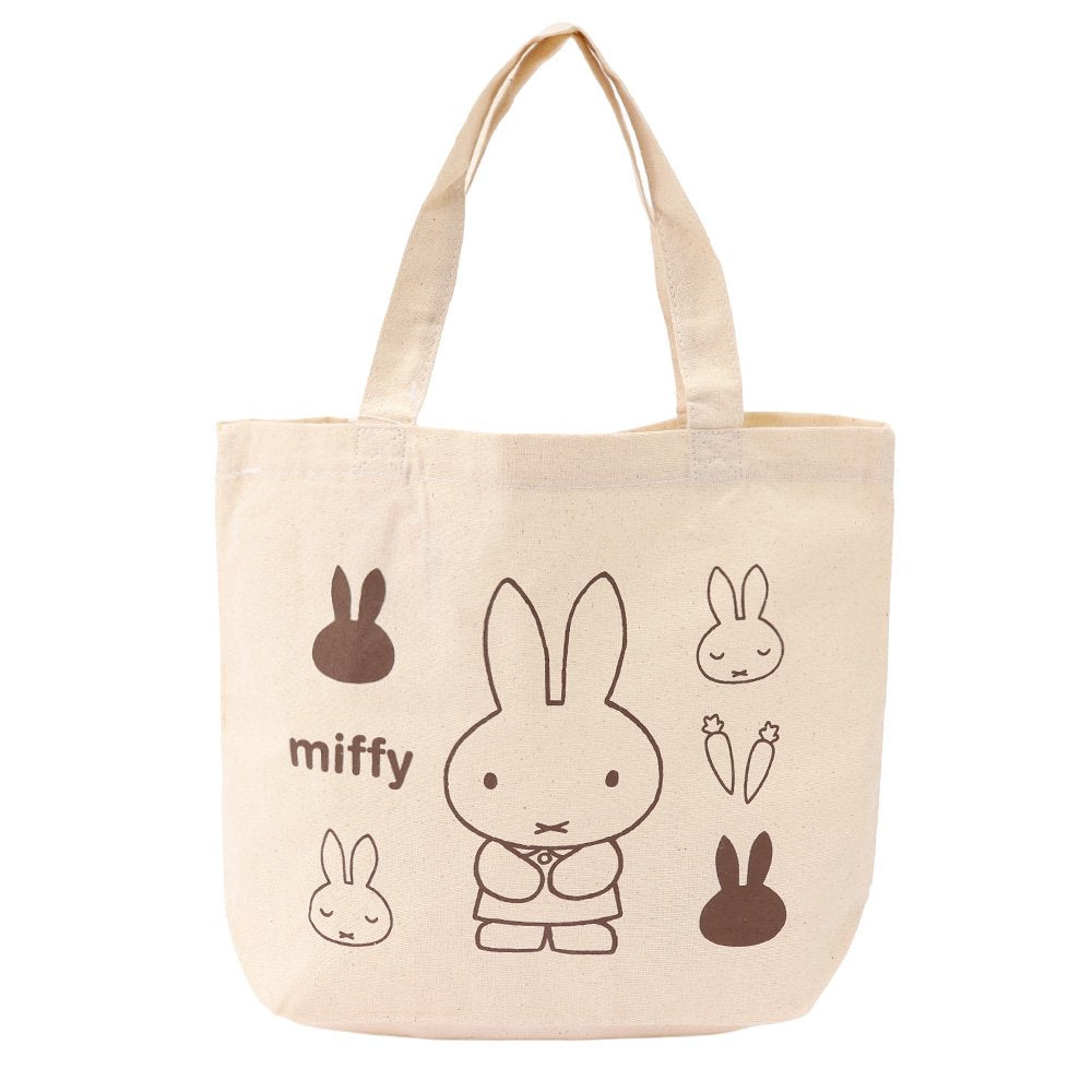 An officially licensed Miffy canvas tote bag in a cream color, showing various Miffy poses and carrots in brown ink.