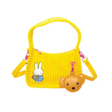 Officially Licensed Yellow Corduroy Miffy Shoulder Bag with strap and top handle. The front features a patch with "miffy & Whatever!" and embroidered flowers, while the back has an embroidered image of Miffy holding flowers and a hanging brown bear PU keychain charm. Ideal Miffy collector's item or novelty handbag