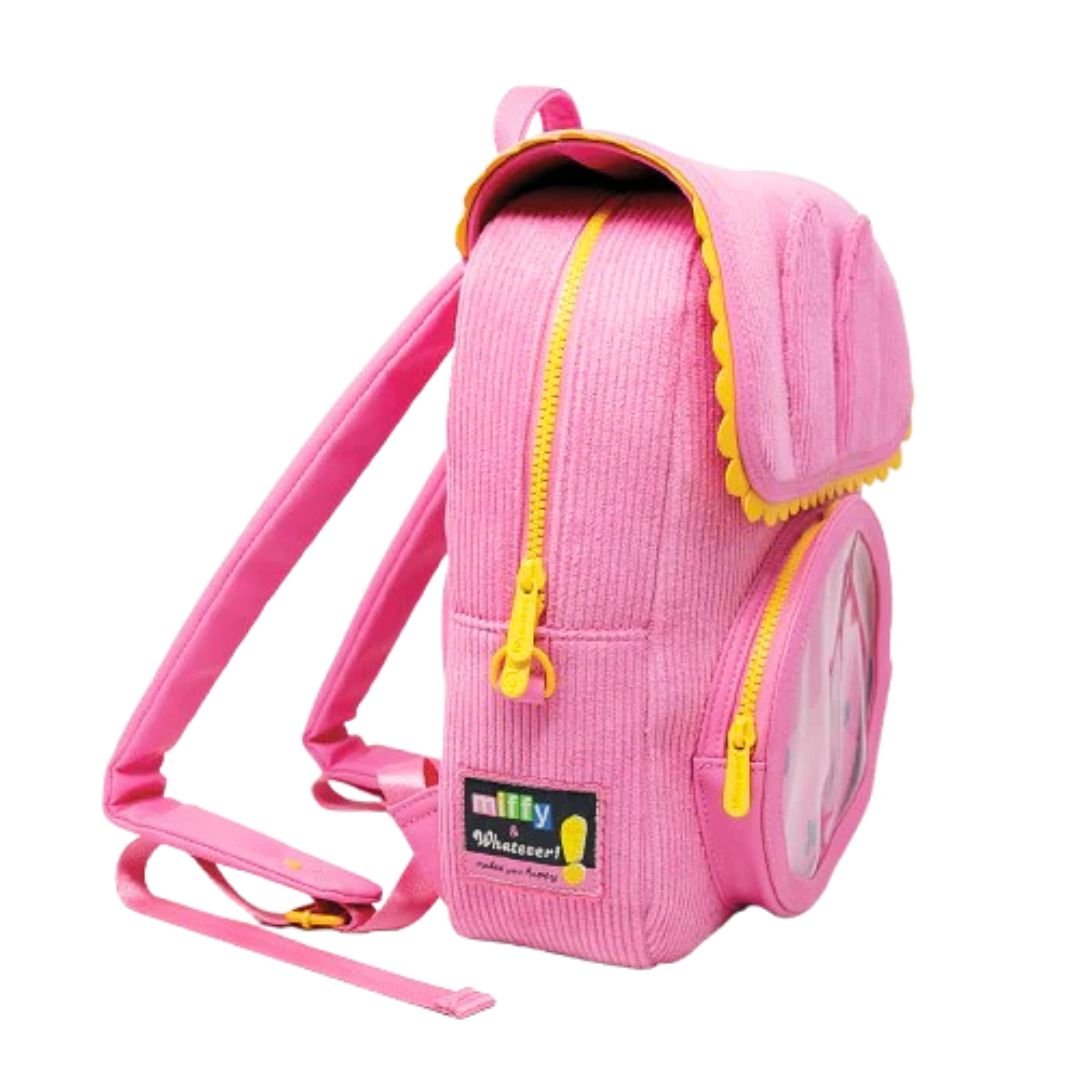 Officially licensed pink corduroy Miffy backpack. The front panel has a circular window pocket with Miffy's face, and the top flap is shaped like rabbit ears with a scalloped yellow trim.