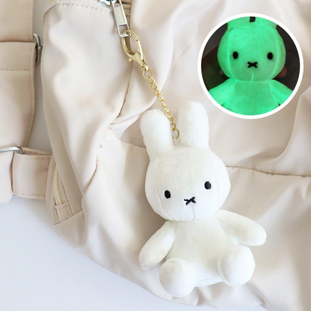Official Miffy Glow in the Dark Mascot Plush Keychain and Bag Clip Charm; featuring a white rabbit plush with green embroidery that illuminates in darkness. A premium, functional Y2K aesthetic accessory for adult bag decor, night visibility, and unique nostalgic Easter basket stuffers.