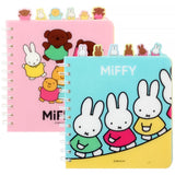 Officially licensed Miffy spiral notebooks in pink and blue, featuring die-cut character tabs of Miffy and friends along the top edge and white spiral binding.