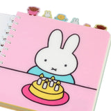 Officially licensed Miffy spiral notebooks in pink and blue, featuring die-cut character tabs of Miffy and friends along the top edge and white spiral binding.