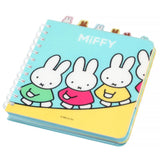 Officially licensed Miffy spiral notebooks in pink and blue, featuring die-cut character tabs of Miffy and friends along the top edge and white spiral binding.