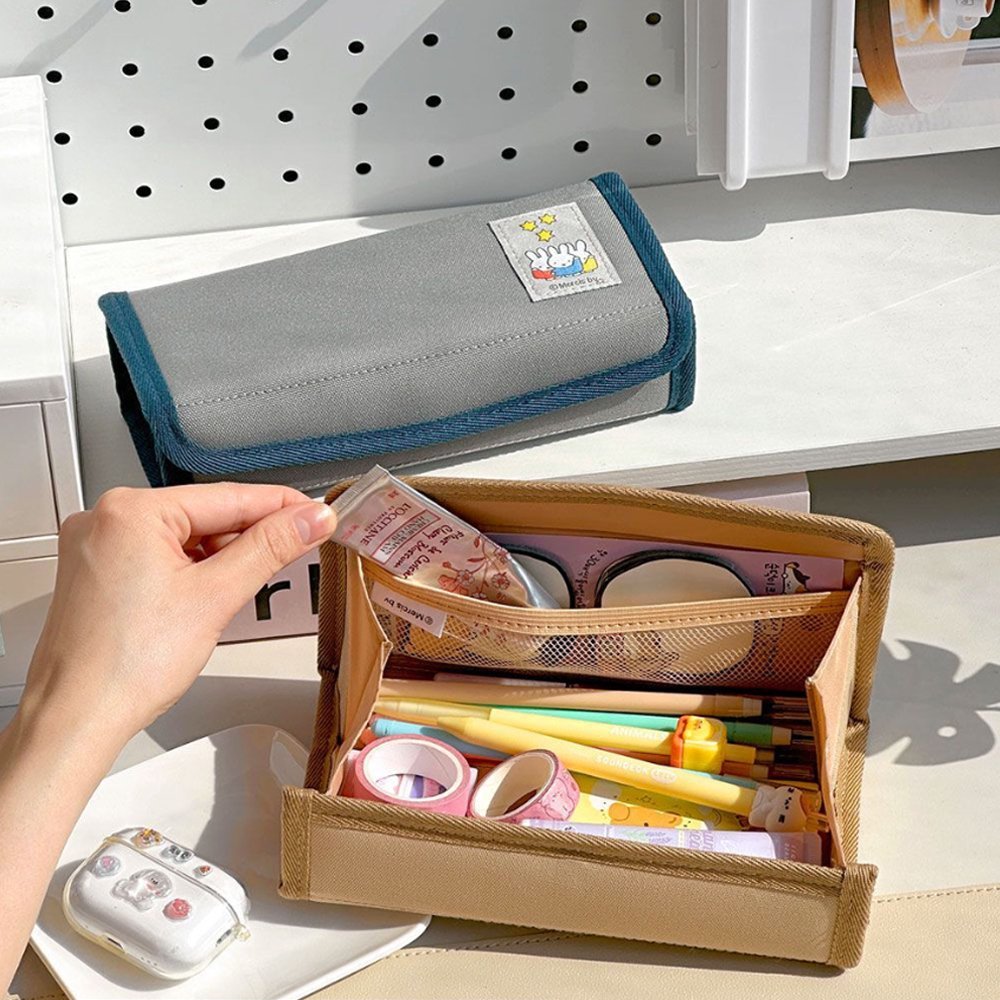 An officially licensed Miffy magnetic pencil case in beige and grey, featuring a colorful embroidered patch of Miffy characters on the front cover.