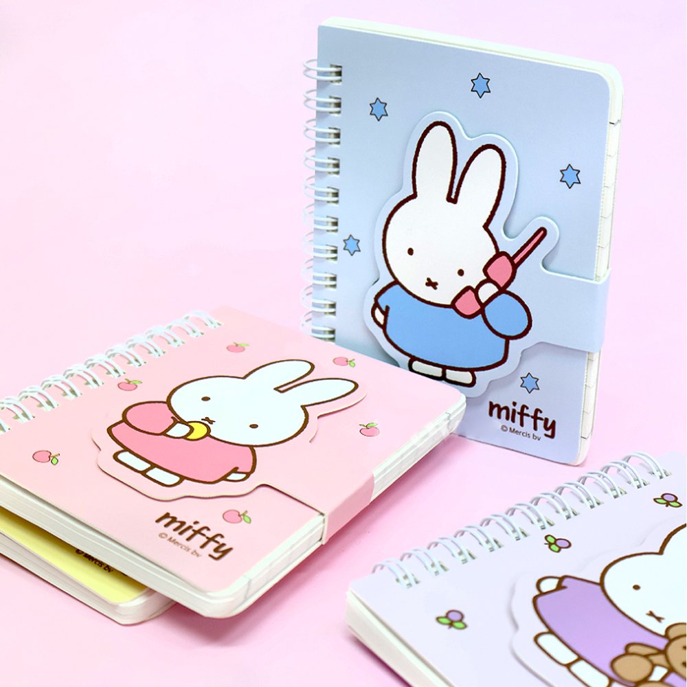 A series of officially licensed Miffy spiral notebooks in pastel pink, blue, and purple, featuring a large magnetic character buckle. The interior shows lined paper with a small Miffy graphic in the bottom corner, highlighting the notebook's functional and cute design.