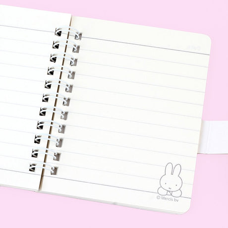 A series of officially licensed Miffy spiral notebooks in pastel pink, blue, and purple, featuring a large magnetic character buckle. The interior shows lined paper with a small Miffy graphic in the bottom corner, highlighting the notebook's functional and cute design.