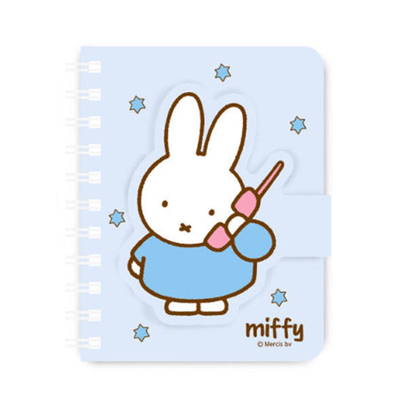 A series of officially licensed Miffy spiral notebooks in pastel pink, blue, and purple, featuring a large magnetic character buckle. The interior shows lined paper with a small Miffy graphic in the bottom corner, highlighting the notebook's functional and cute design.