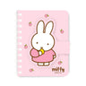 A series of officially licensed Miffy spiral notebooks in pastel pink, blue, and purple, featuring a large magnetic character buckle. The interior shows lined paper with a small Miffy graphic in the bottom corner, highlighting the notebook's functional and cute design.