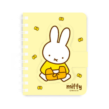 A series of officially licensed Miffy spiral notebooks in pastel pink, blue, and purple, featuring a large magnetic character buckle. The interior shows lined paper with a small Miffy graphic in the bottom corner, highlighting the notebook's functional and cute design.