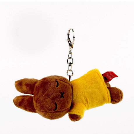 Officially licensed Melanie sleeping plush keychain featuring embroidered closed eyes and an 'X' mouth. Brown plush wearing yellow top. Ideal collectible bag charms, backpack zipper pulls or gift.