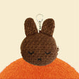 An officially licensed Miffy Melanie brown tweed pouch featuring sleeping embroidered eyes and an attached silver clip.