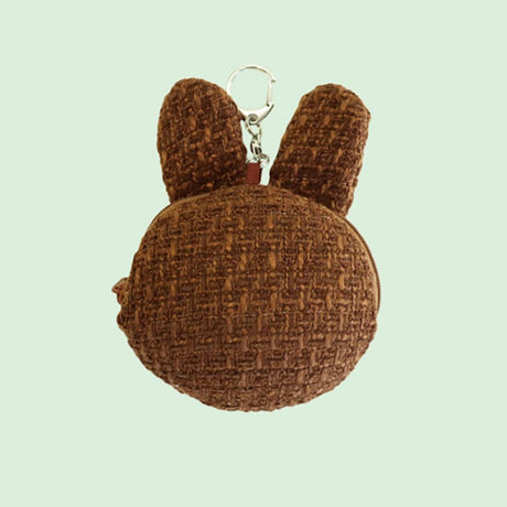 An officially licensed Miffy Melanie brown tweed pouch featuring sleeping embroidered eyes and an attached silver clip.