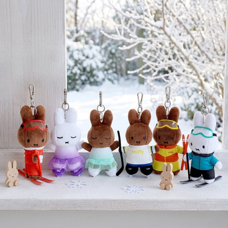 An officially licensed Miffy plush keychains from the Winter Sports series, featuring Miffy and Melanie dressed as a skier, figure skater, hockey player, and ski jumper in various colorful outfits.