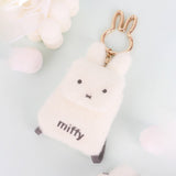 An officially licensed Miffy plush mini backpack pouch keychain in brown, ivory, pink, and black, featuring a gold bunny shaped clip.