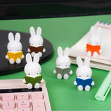 Officially licensed Miffy Reading a Book Mini Figure Blind Box featuring Miffy sculpted sitting down and holding an open book in various colors