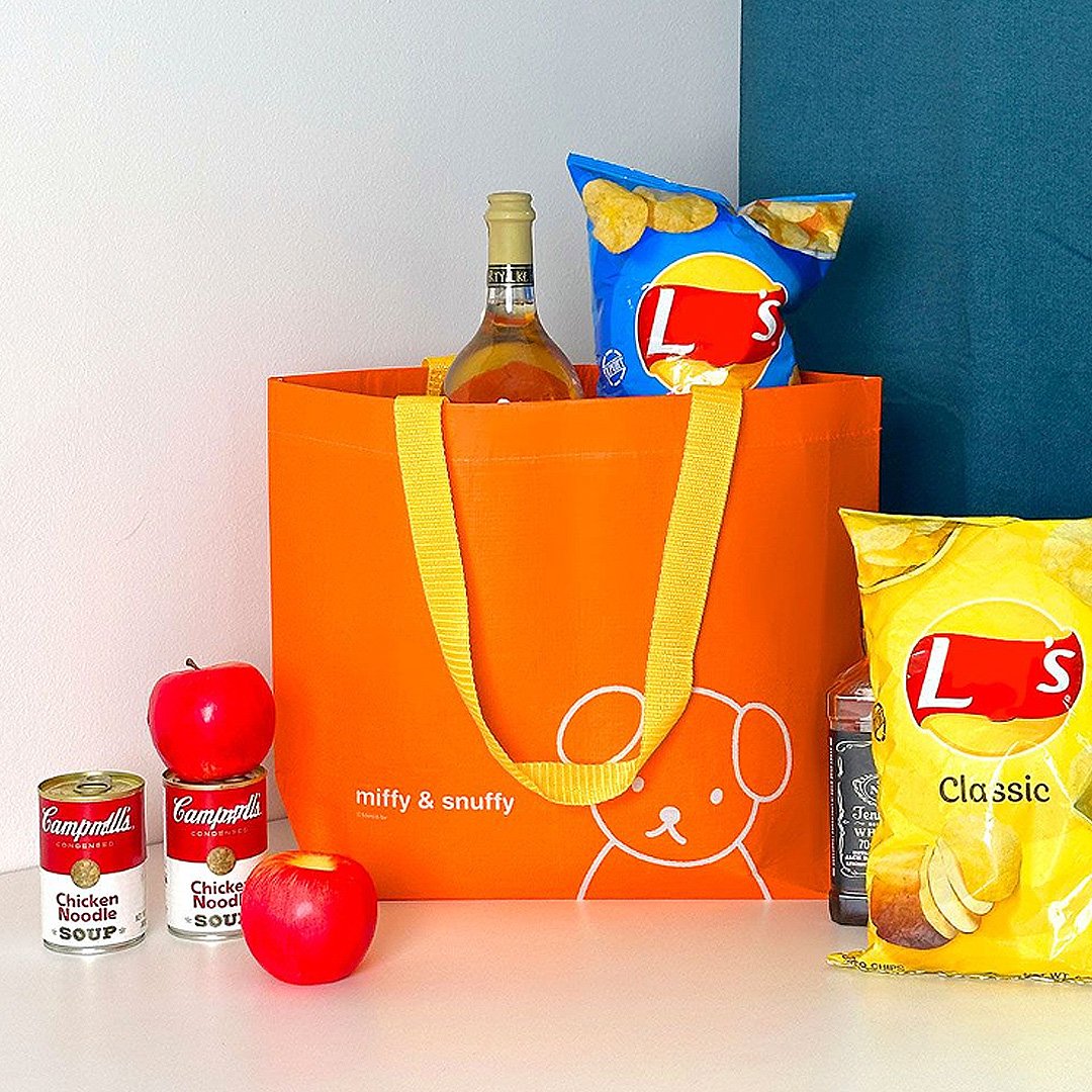 Officially licensed Miffy & Snuffy Reusable Tote Bag. The bags are Made from durable, wipeable tarpaulin material, featuring one in bright orange with yellow handles and Snuffy dog. Ideal for shopping, groceries, or carrying goods.