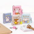 An officially licensed collection of Miffy secret mini notebooks in soft pink, light blue, blue, and grey. Each notebook features a padded cover with Miffy or Boris Bear illustrations, a silver ball chain, and a color-coordinated miniature padlock with keys.