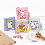 An officially licensed collection of Miffy secret mini notebooks in soft pink, light blue, blue, and grey. Each notebook features a padded cover with Miffy or Boris Bear illustrations, a silver ball chain, and a color-coordinated miniature padlock with keys.