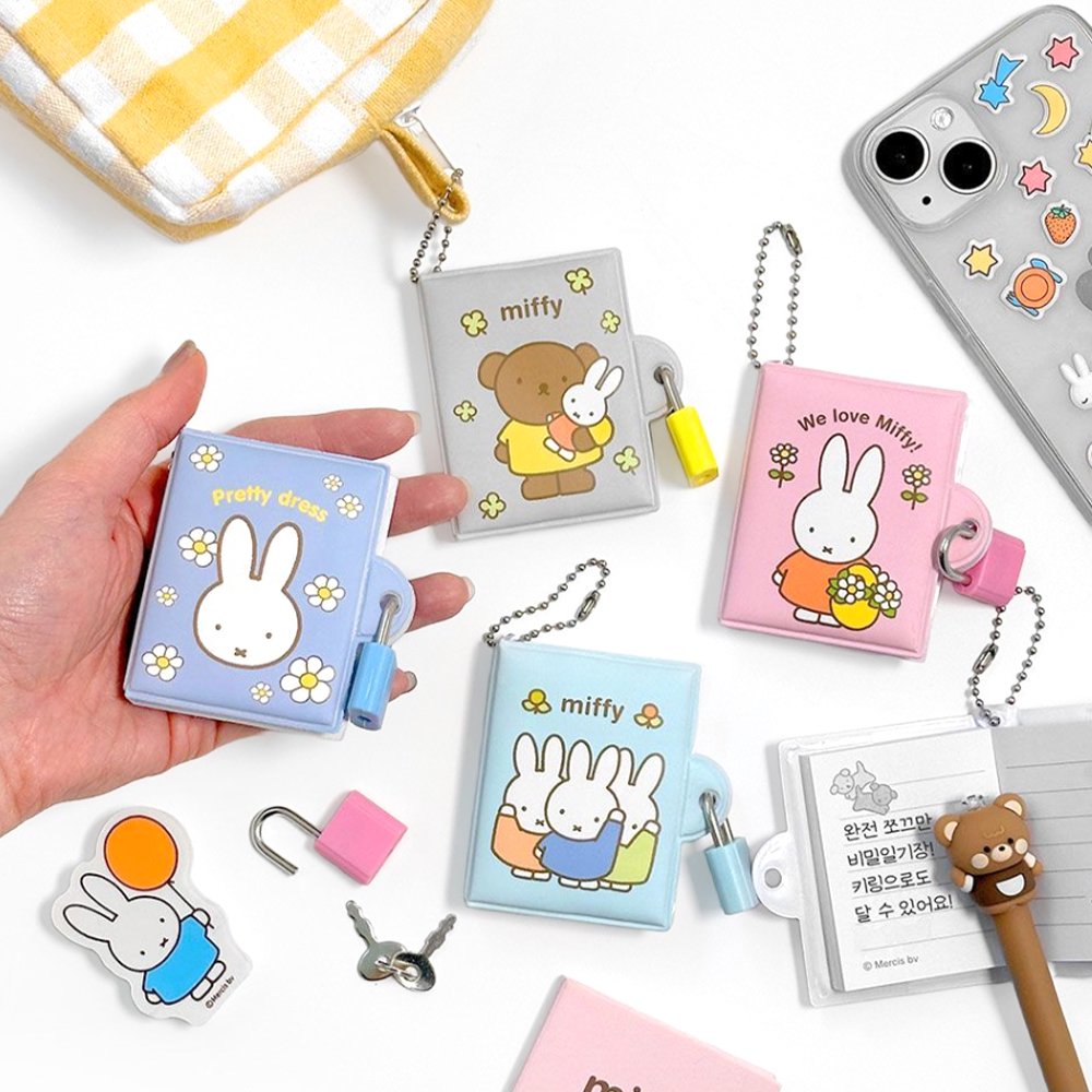 An officially licensed collection of Miffy secret mini notebooks in soft pink, light blue, blue, and grey. Each notebook features a padded cover with Miffy or Boris Bear illustrations, a silver ball chain, and a color-coordinated miniature padlock with keys.