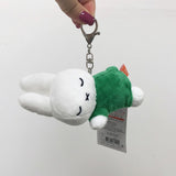 Officially licensed Miffy plush sleeping keychains. Soft dolls include white Miffy plush is wearing green with embroidered closed eyes and an 'X' mouth. Ideal collectible bag charms or backpack zipper pulls.
