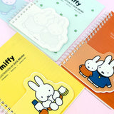 Four colorful spiral notebooks in pink, green, yellow, and orange, each featuring an officially licensed Miffy memo pad attached to the front cover.