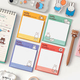 A collection of four officially licensed Miffy sticky note pads in soft shades of red, yellow, green, and blue. Each pad features a white grid writing area decorated with minimalist illustrations of Miffy, a dog, flowers, and beach balls.