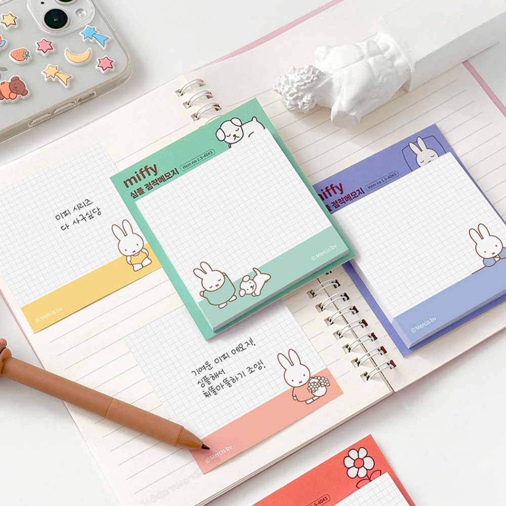 A collection of four officially licensed Miffy sticky note pads in soft shades of red, yellow, green, and blue. Each pad features a white grid writing area decorated with minimalist illustrations of Miffy, a dog, flowers, and beach balls.