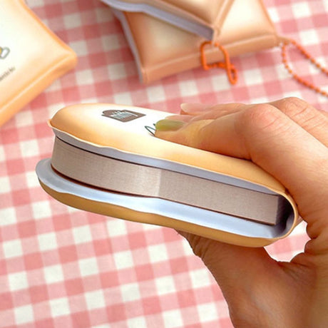Officially licensed Miffy memo pads shaped like slices of toast. The pads feature a soft tan cover with character illustrations and include orange ball chains.