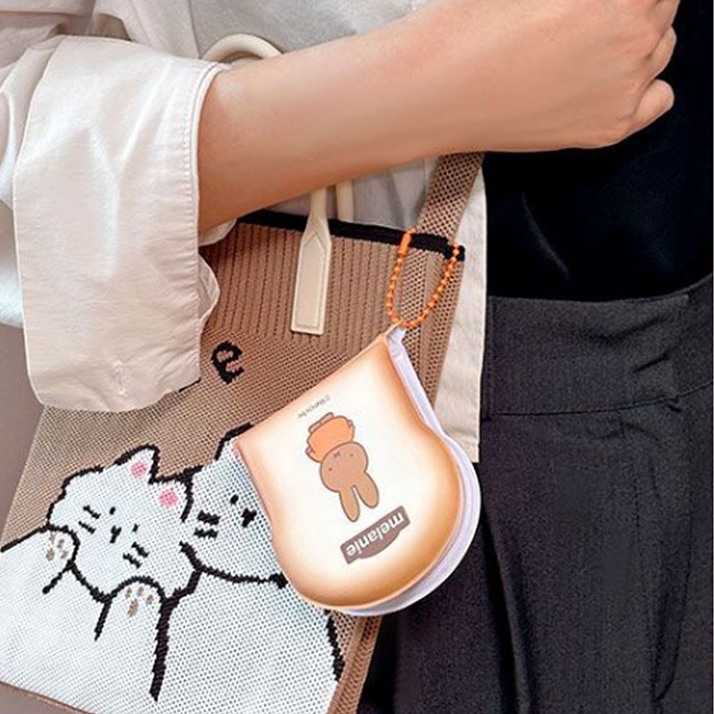 Officially licensed Miffy memo pads shaped like slices of toast. The pads feature a soft tan cover with character illustrations and include orange ball chains.