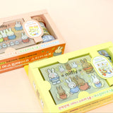An officially licensed Miffy stationery set featuring five rolls of decorative washi tape and five shiny sticker sheets displayed with a transparent storage case. The collection showcases classic Dick Bruna illustrations of Miffy the rabbit and friends in soft pastel colors.
