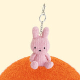 Four officially licensed Miffy textured tweed plush keychains lined up in pink, sage green, cream, and navy blue with attached silver keyrings