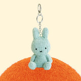 Four officially licensed Miffy textured tweed plush keychains lined up in pink, sage green, cream, and navy blue with attached silver keyrings
