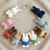 Officially licensed Miffy textured tweed plush keychains lined up in cream, pink, orange, sky blue, blue, green, yellow, mint green, and navy with attached silver keyrings