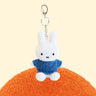 Four officially licensed Miffy plush keychains wearing knit sweaters in orange, green, light blue, and dark blue standing together. Each plush includes an attached silver chain with a lobster clasp at the top.