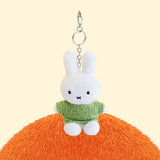 Four officially licensed Miffy plush keychains wearing knit sweaters in orange, green, light blue, and dark blue standing together. Each plush includes an attached silver chain with a lobster clasp at the top.