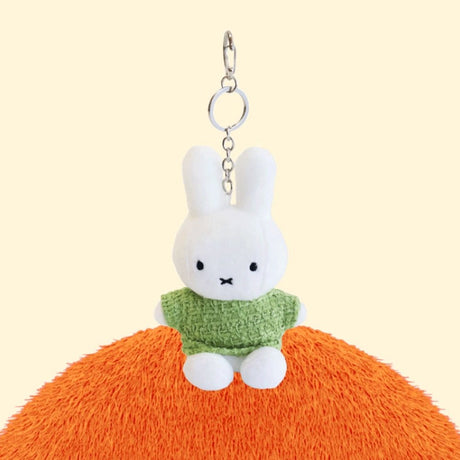 Four officially licensed Miffy plush keychains wearing knit sweaters in orange, green, light blue, and dark blue standing together. Each plush includes an attached silver chain with a lobster clasp at the top.