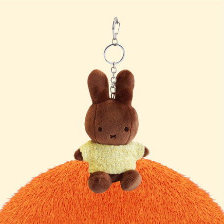 Four officially licensed Miffy plush keychains wearing knit sweaters in orange, green, light blue, and dark blue standing together. Each plush includes an attached silver chain with a lobster clasp at the top.